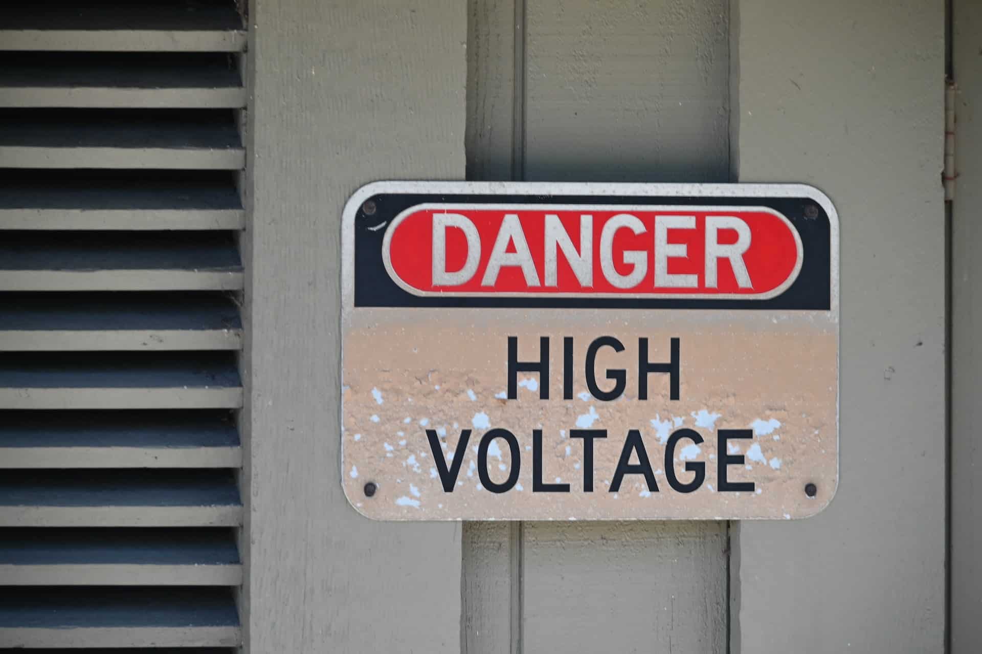 A sign on a device stating Danger High Voltage