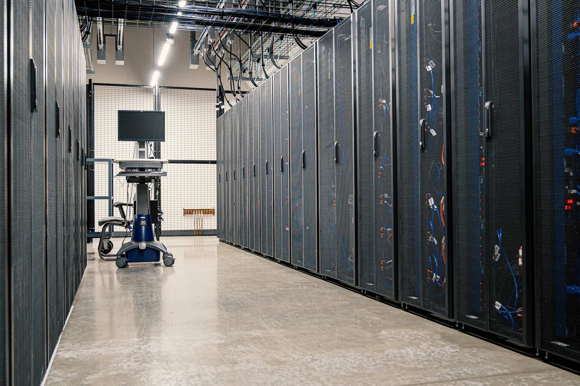 a picture of racks in a data center with a crash cart